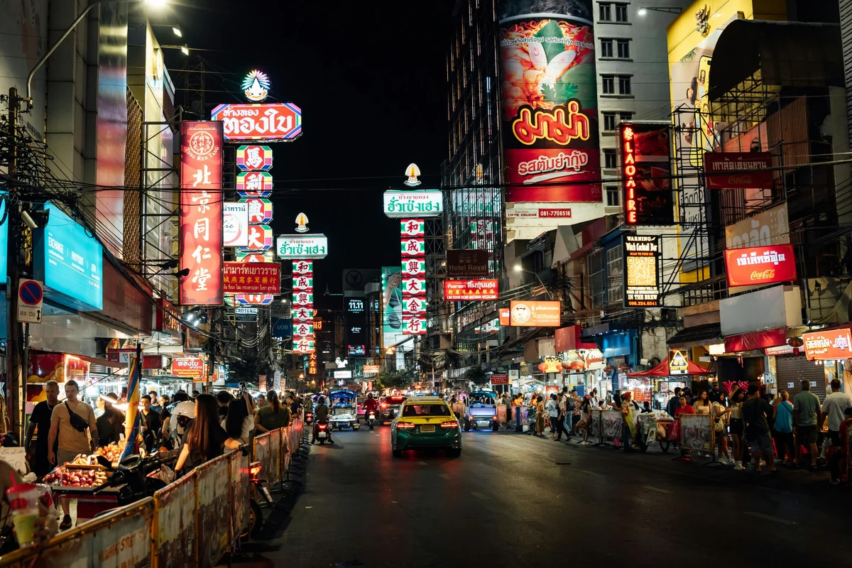 An illuminated street and food stalls in Bangkok